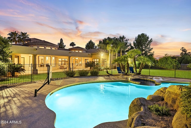 view of pool at dusk