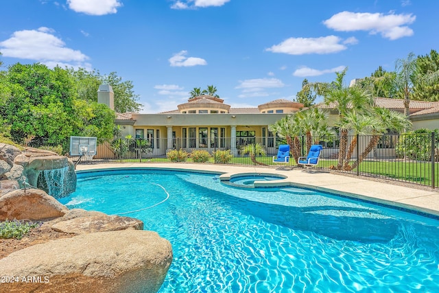 view of swimming pool with an in ground hot tub