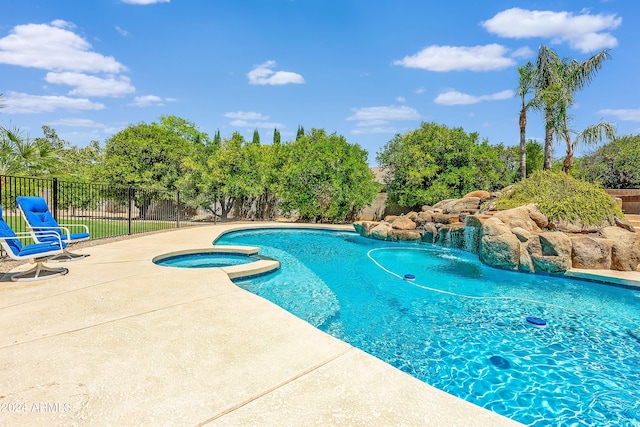 view of pool with an in ground hot tub