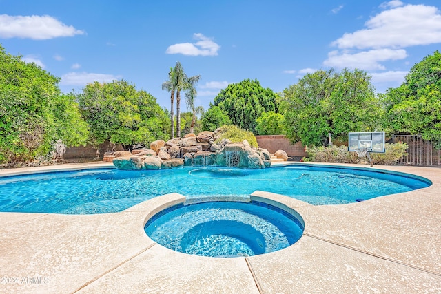 view of pool featuring an in ground hot tub