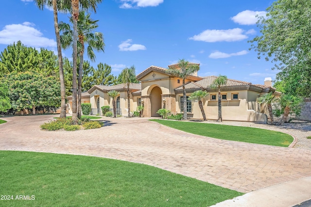 mediterranean / spanish home with a front yard