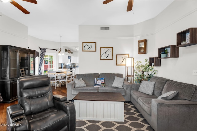 living area featuring ceiling fan, visible vents, and wood finished floors