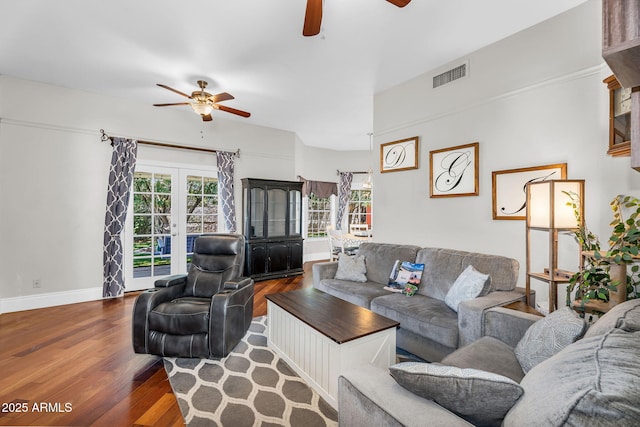 living area with visible vents, ceiling fan, and wood finished floors