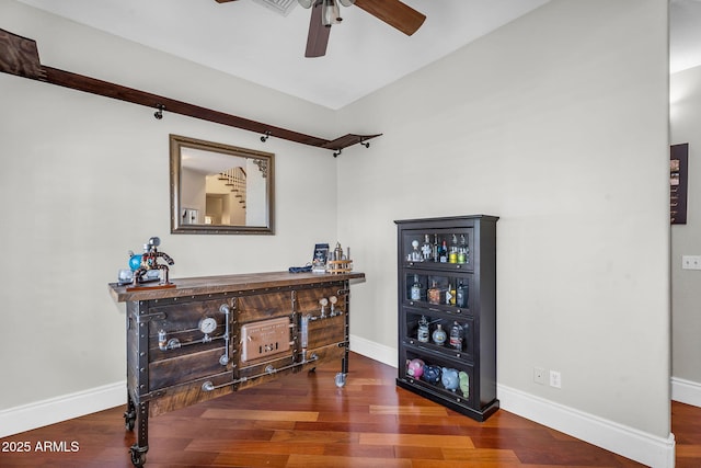 bar with baseboards, a dry bar, ceiling fan, and wood finished floors