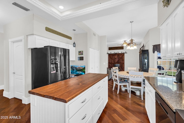 kitchen with visible vents, butcher block countertops, fridge with ice dispenser, and dark wood-type flooring