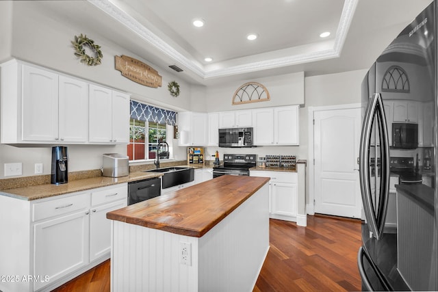 kitchen featuring a sink, wood counters, black appliances, and dark wood-type flooring