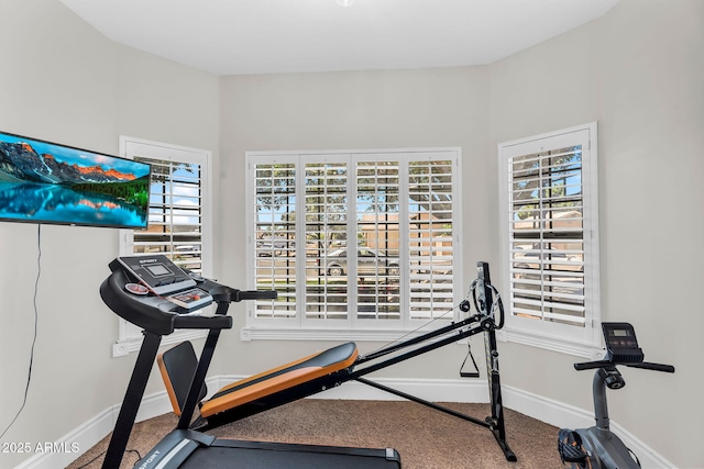 workout room with baseboards and carpet flooring