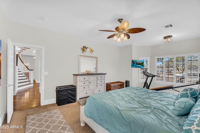 bedroom with baseboards, visible vents, ceiling fan, and carpet