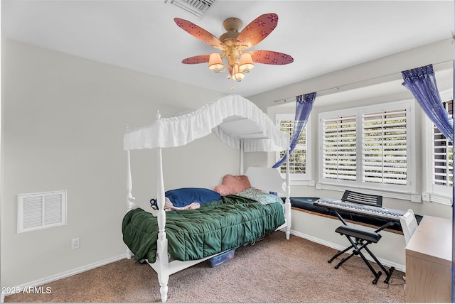 carpeted bedroom featuring visible vents, a ceiling fan, and baseboards