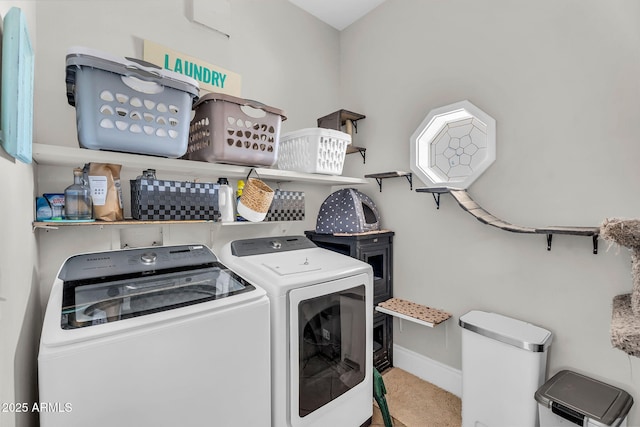 clothes washing area with baseboards, laundry area, and independent washer and dryer