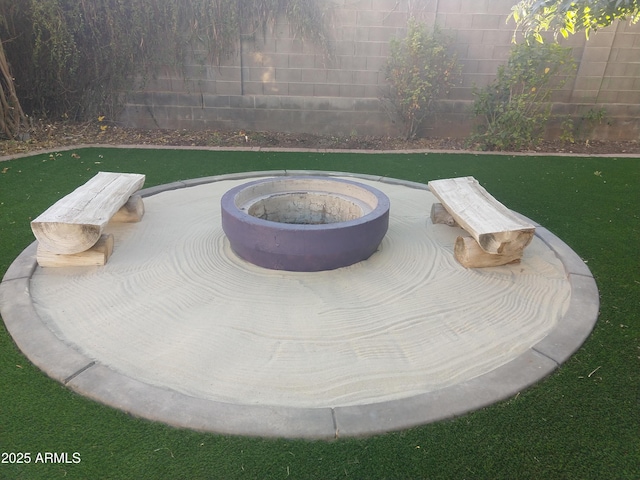 exterior details featuring a fire pit and fence private yard