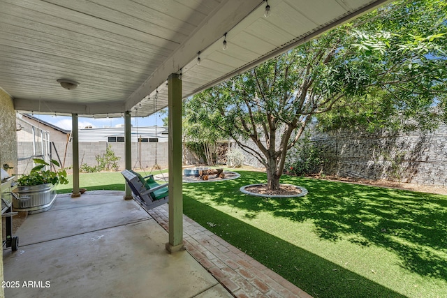 view of patio / terrace with a fenced backyard and an outdoor fire pit