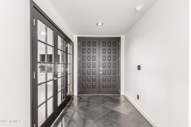 entrance foyer featuring french doors and baseboards