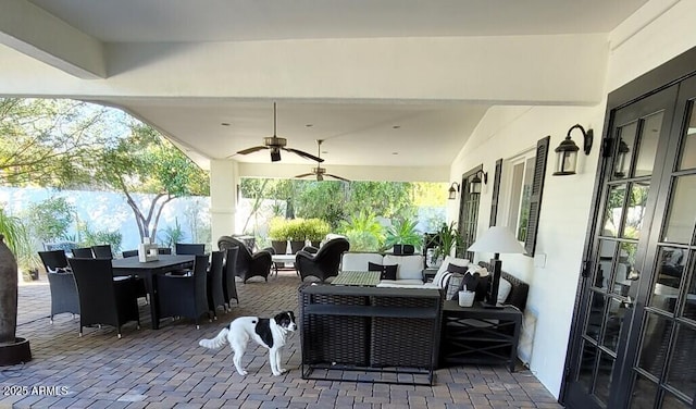 view of patio / terrace with outdoor dining area, an outdoor living space, and a ceiling fan