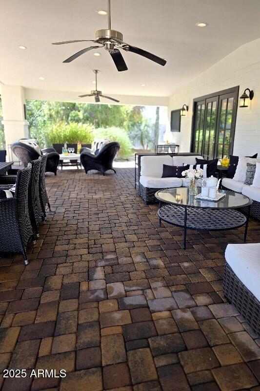 view of patio / terrace featuring an outdoor hangout area, french doors, and a ceiling fan