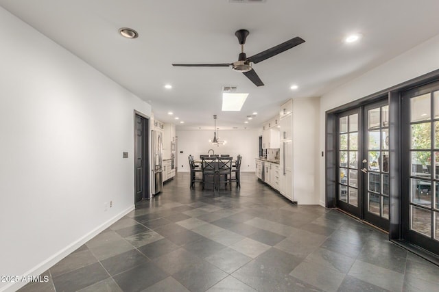 interior space with recessed lighting, visible vents, baseboards, and ceiling fan with notable chandelier