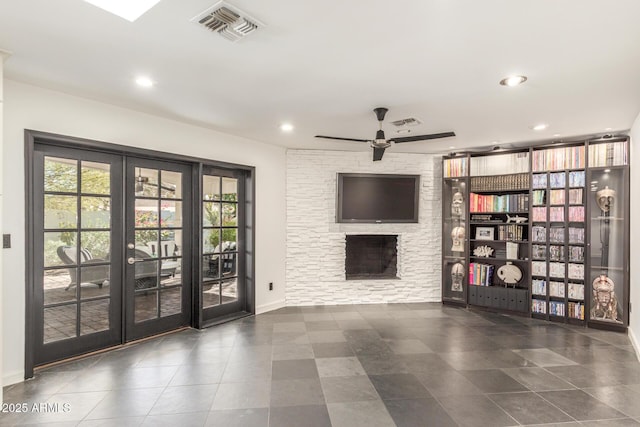 unfurnished living room featuring recessed lighting, visible vents, french doors, and a stone fireplace