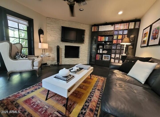 living room with a large fireplace and recessed lighting