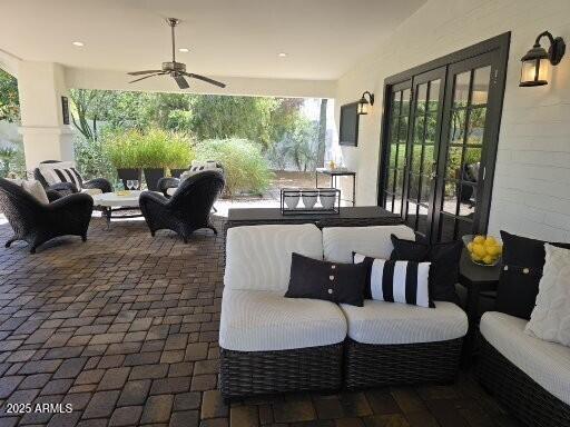 view of patio / terrace featuring french doors, an outdoor living space, and a ceiling fan