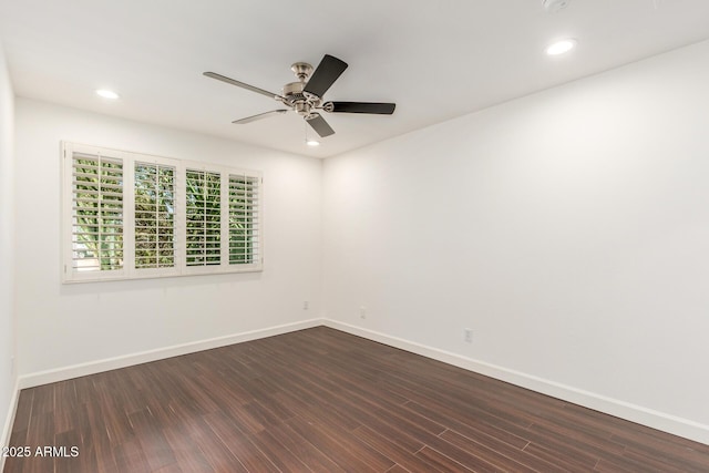 spare room featuring dark wood-style floors, recessed lighting, baseboards, and a ceiling fan