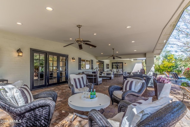 view of patio with outdoor dining space, french doors, ceiling fan, and an outdoor living space