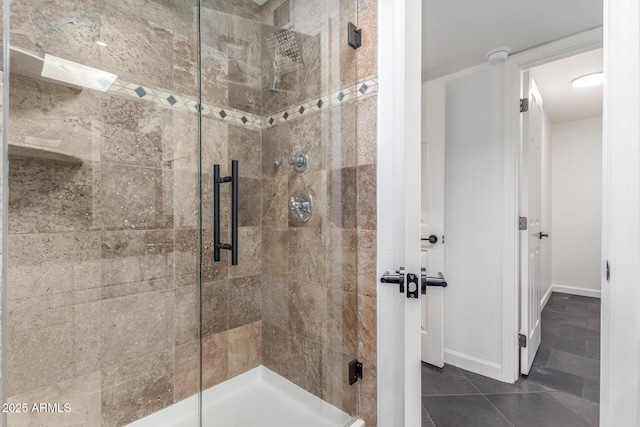 full bathroom with tile patterned floors, a shower stall, and baseboards