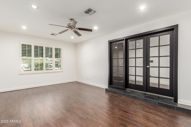 unfurnished room with visible vents, dark wood-style flooring, and recessed lighting