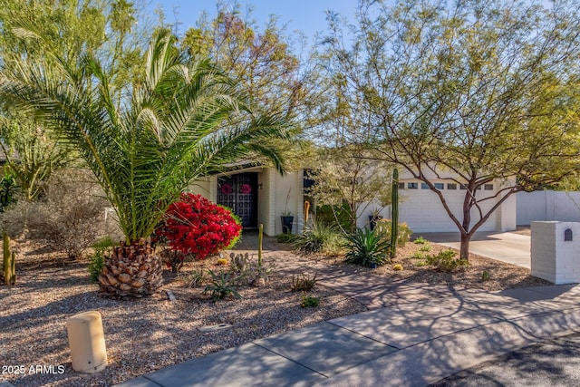 obstructed view of property with concrete driveway and an attached garage