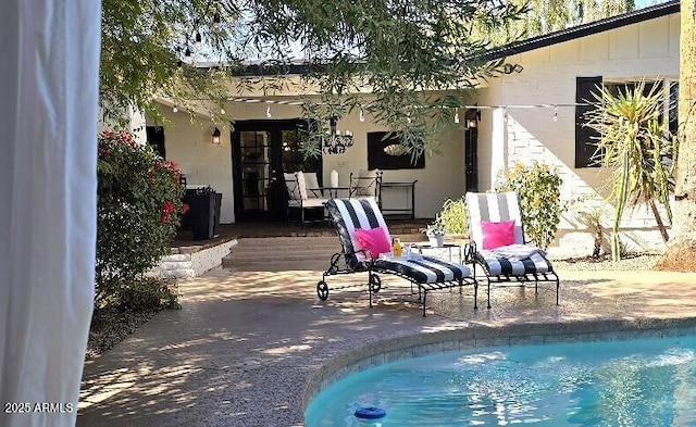 outdoor pool featuring a patio