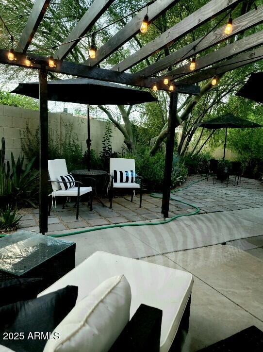 view of patio with fence, an outdoor hangout area, and a pergola