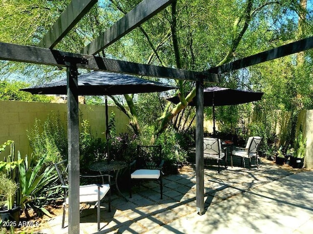 view of patio / terrace featuring fence