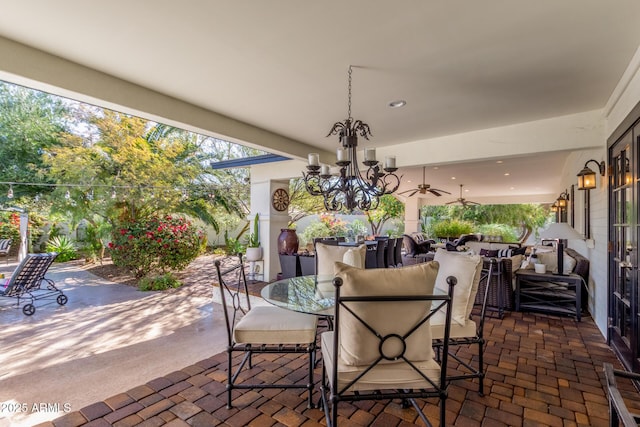 view of patio with a ceiling fan, outdoor dining space, and an outdoor hangout area