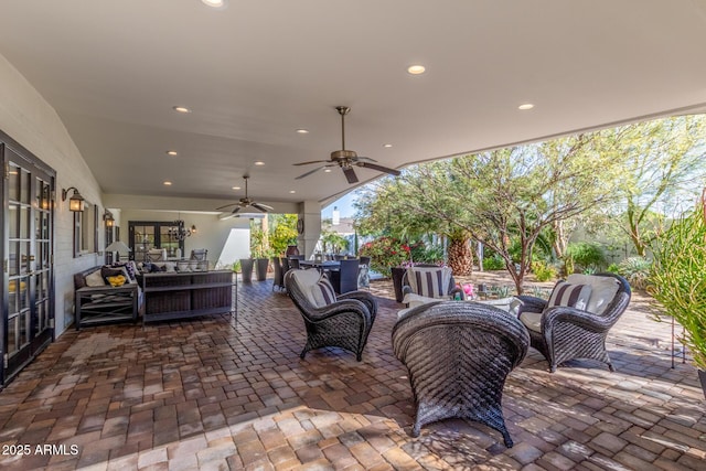 view of patio featuring a ceiling fan and an outdoor living space