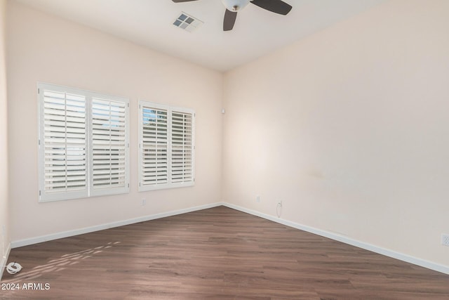 spare room with ceiling fan and dark hardwood / wood-style flooring