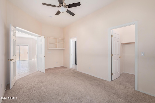 spare room featuring ceiling fan and light colored carpet