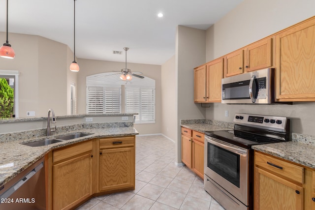 kitchen featuring ceiling fan, sink, light stone counters, decorative light fixtures, and appliances with stainless steel finishes