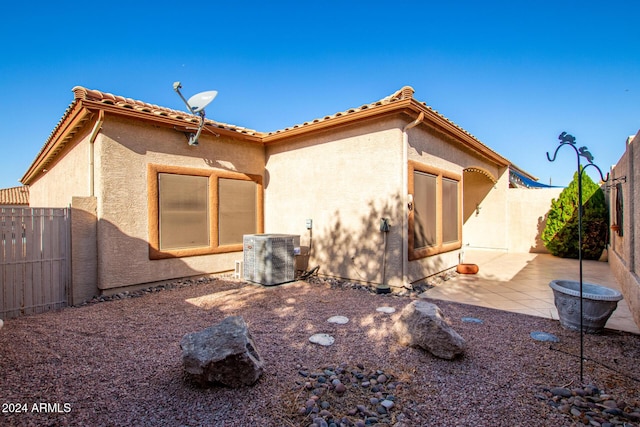 view of home's exterior with central air condition unit and a patio area