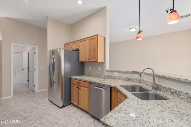 kitchen featuring appliances with stainless steel finishes, light stone counters, sink, light tile patterned floors, and pendant lighting