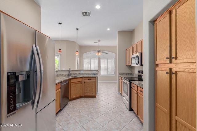 kitchen with hanging light fixtures, ceiling fan, light tile patterned floors, light stone countertops, and appliances with stainless steel finishes