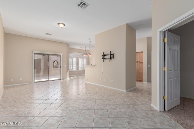 unfurnished room with ceiling fan and light tile patterned flooring