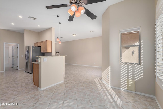 kitchen with ceiling fan, stainless steel fridge, light tile patterned flooring, and hanging light fixtures