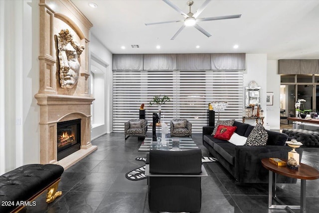 living room featuring ceiling fan and a fireplace