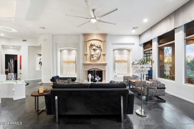 living room with ceiling fan and a large fireplace