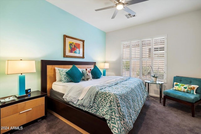 bedroom with dark colored carpet and ceiling fan