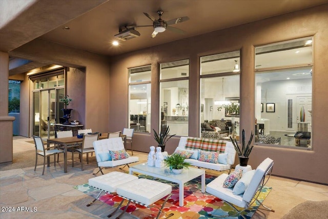 view of patio with an outdoor living space and ceiling fan