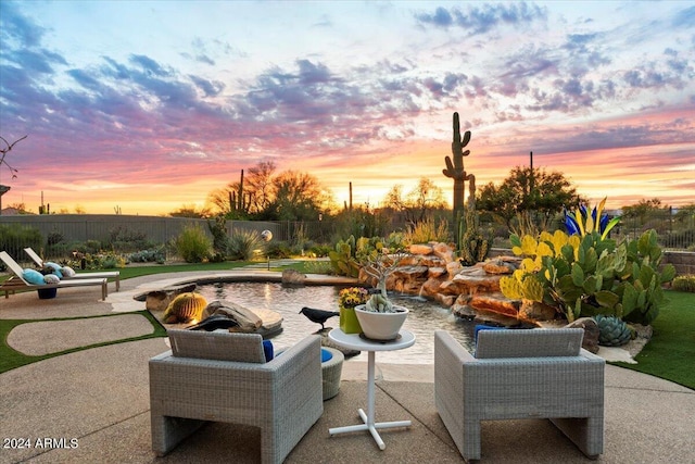 view of patio terrace at dusk