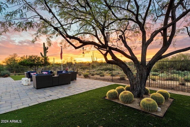 yard at dusk with an outdoor hangout area and a patio area