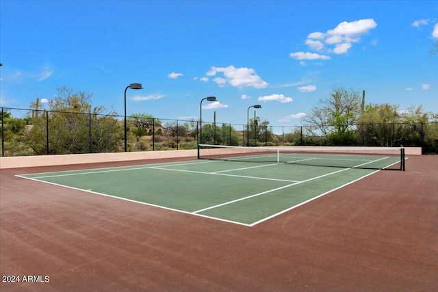 view of tennis court with basketball hoop