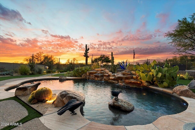 view of pool at dusk