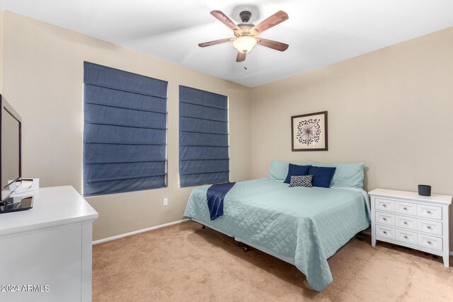 clothes washing area with washer and dryer, ceiling fan, and dark hardwood / wood-style flooring